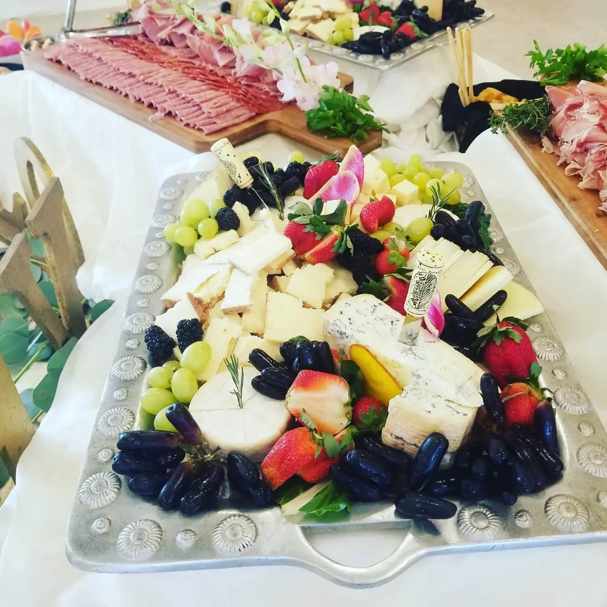 Elegant cheese and charcuterie spread with fresh florals
